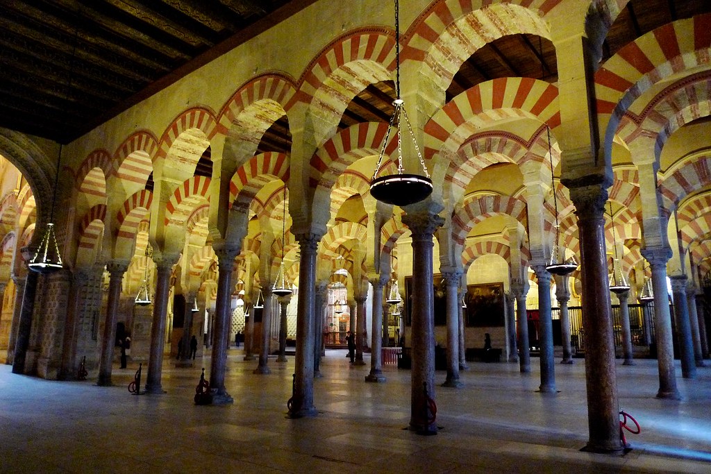 Forest of red and white striped arches inside the Mezquita of Cordoba Spain