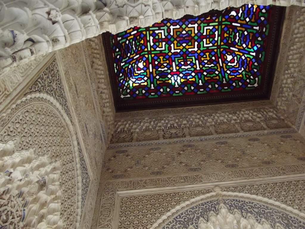 Carved arches and columns of the Court of the Lions in the Nasrid Palaces of the Alhambra