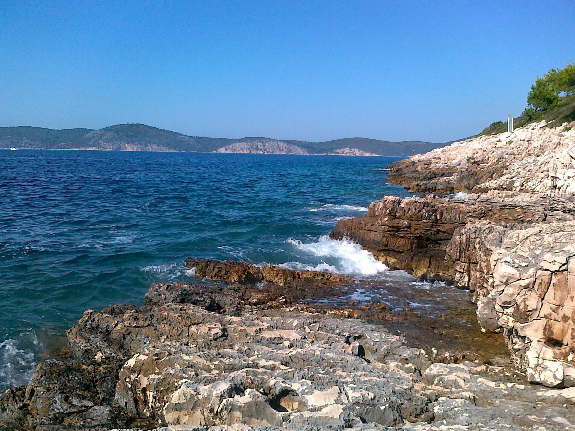 Rocky coastline and clear turquoise water near Palmizana in the Pakleni Islands off Hvar