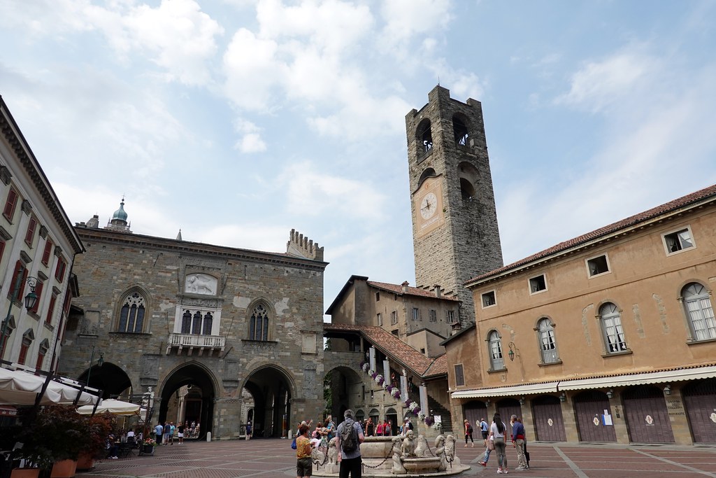 Cafes and the Contarini fountain filling Piazza Vecchia in Bergamo's Upper City