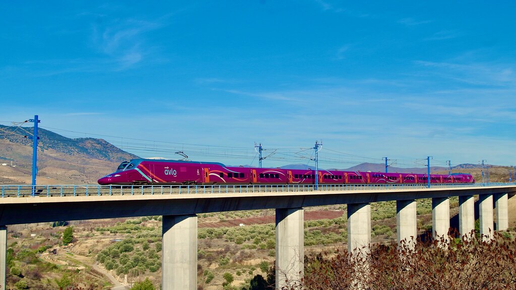 Bright Renfe Avlo high speed train crossing the Spanish countryside