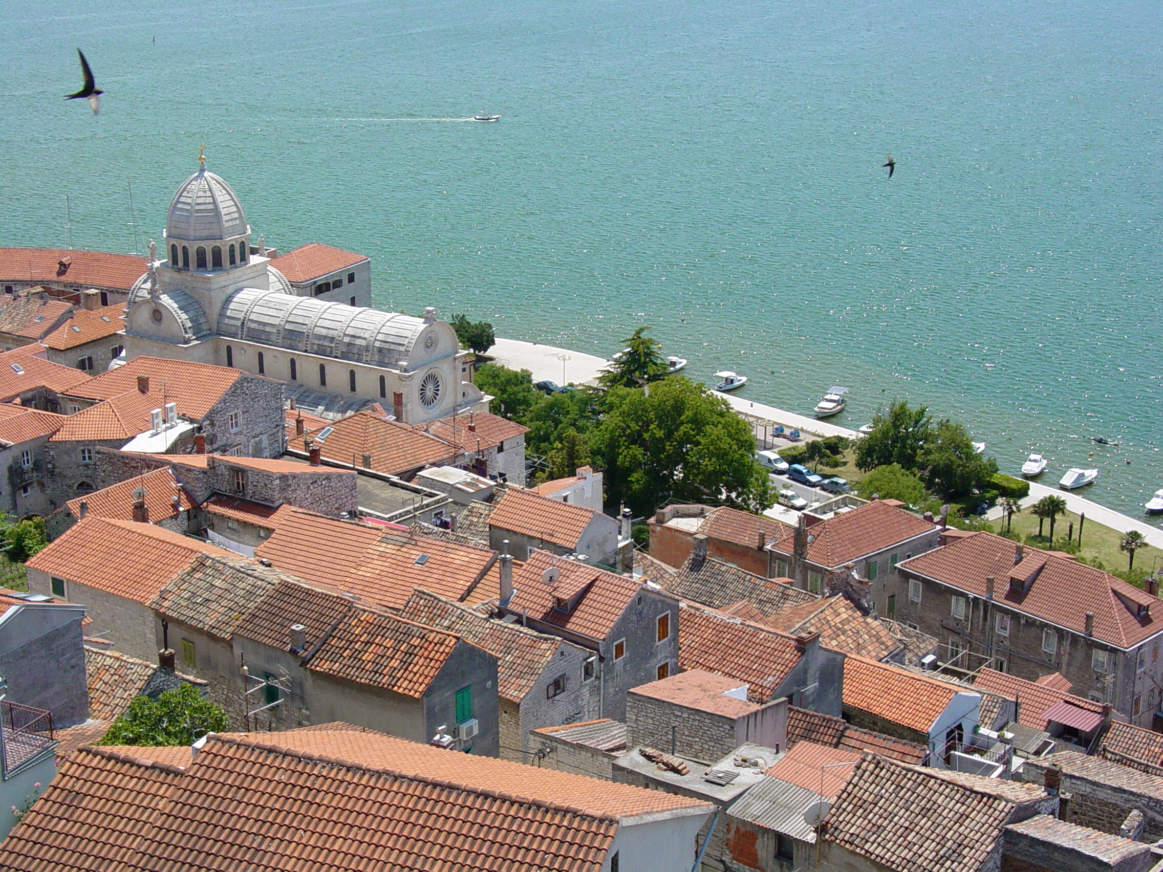 View over the terracotta rooftops of Sibenik old town and its harbour from a hilltop fortress