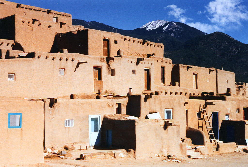 Historic multi-story adobe buildings of Taos Pueblo beneath Taos Mountain in New Mexico