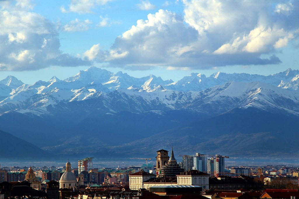 Turin cityscape with baroque architecture and the Alps in the distance
