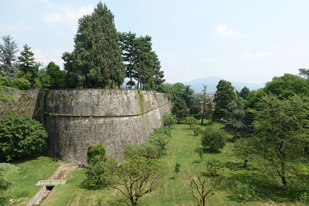 The 16th century Venetian walls circling Bergamo's Citta Alta under a blue sky