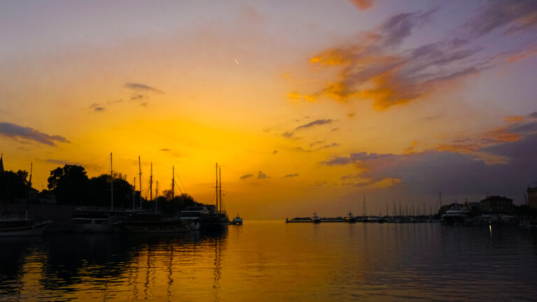 Golden sunset over the Zadar waterfront and old town seen from the city bridge