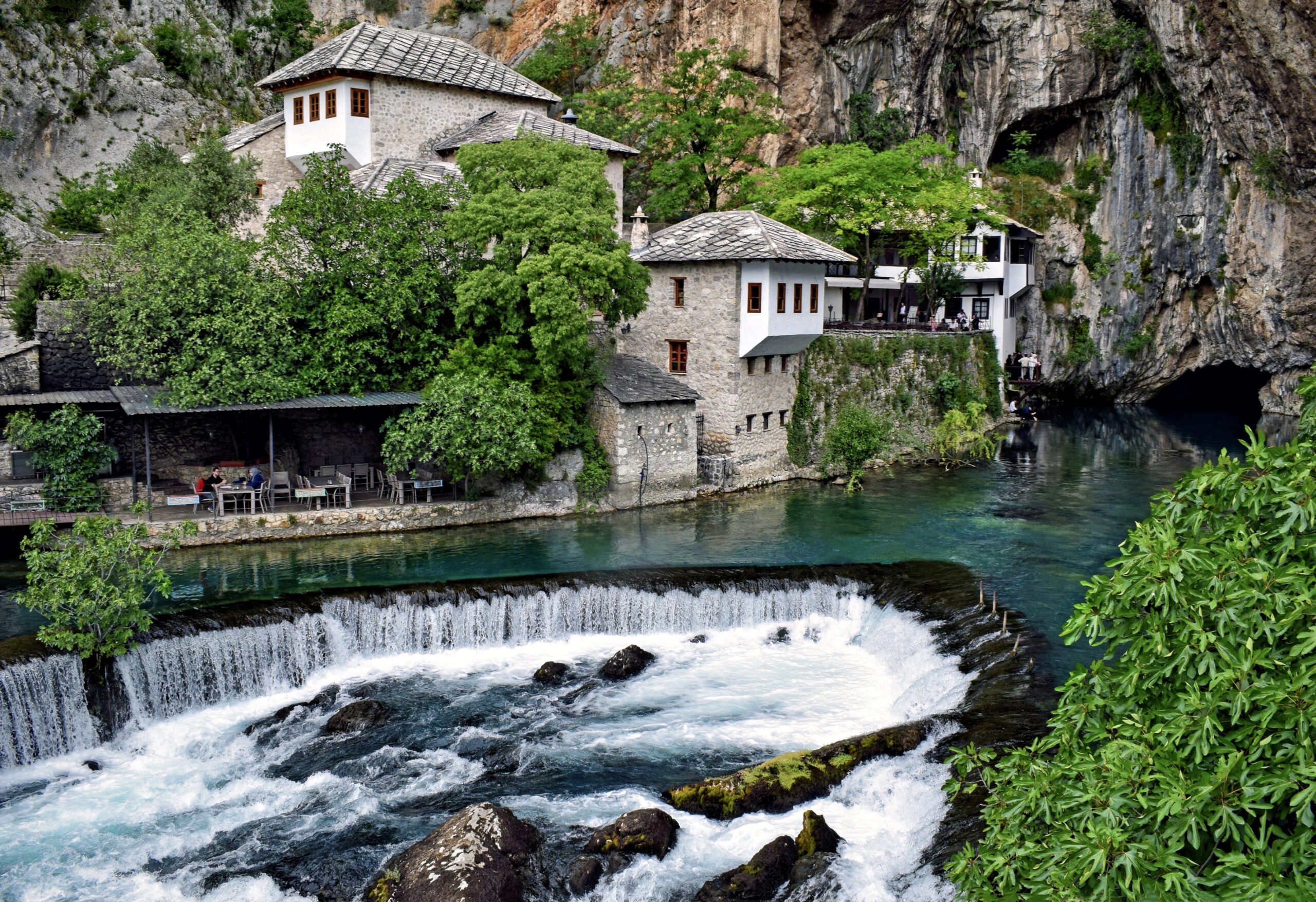 The Blagaj dervish house at the base of the cliff where the Buna river emerges