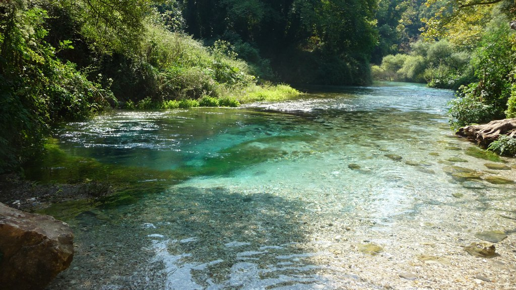 Crystal-clear Bistrice River flowing from the Blue Eye spring near Saranda, Albania