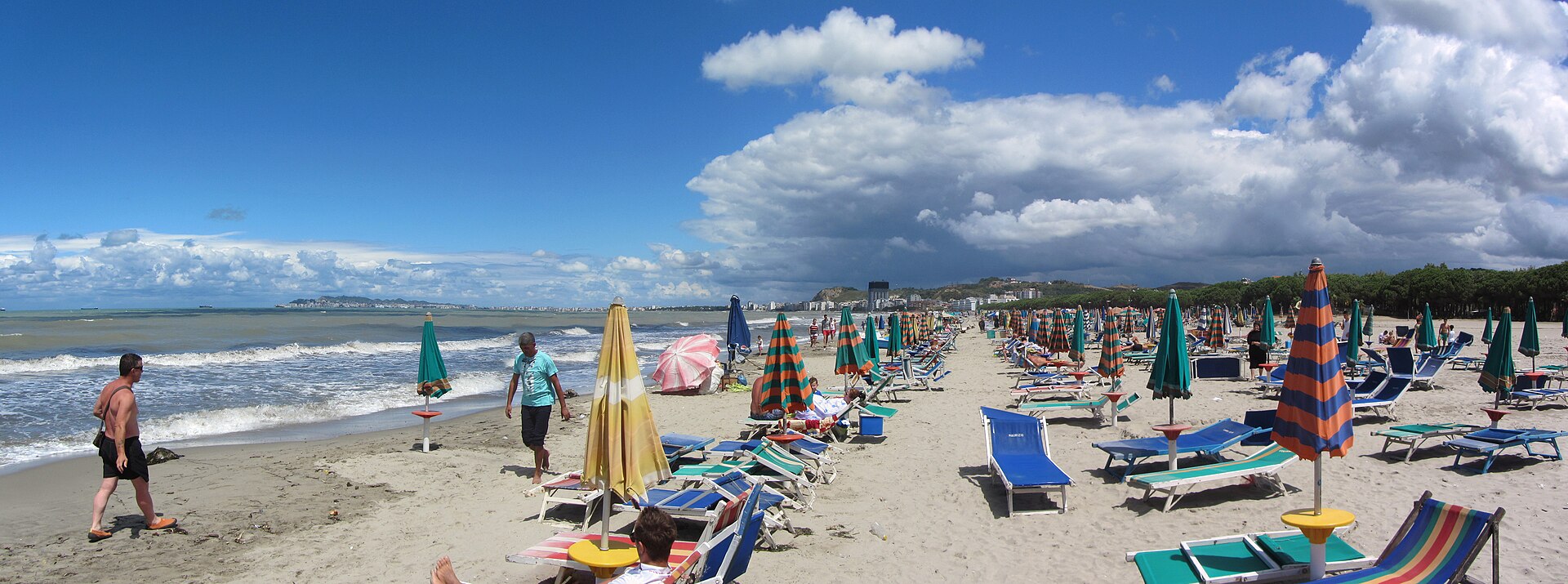 Wide sandy Golem beach with umbrellas and sunbeds just south of Durres, Albania