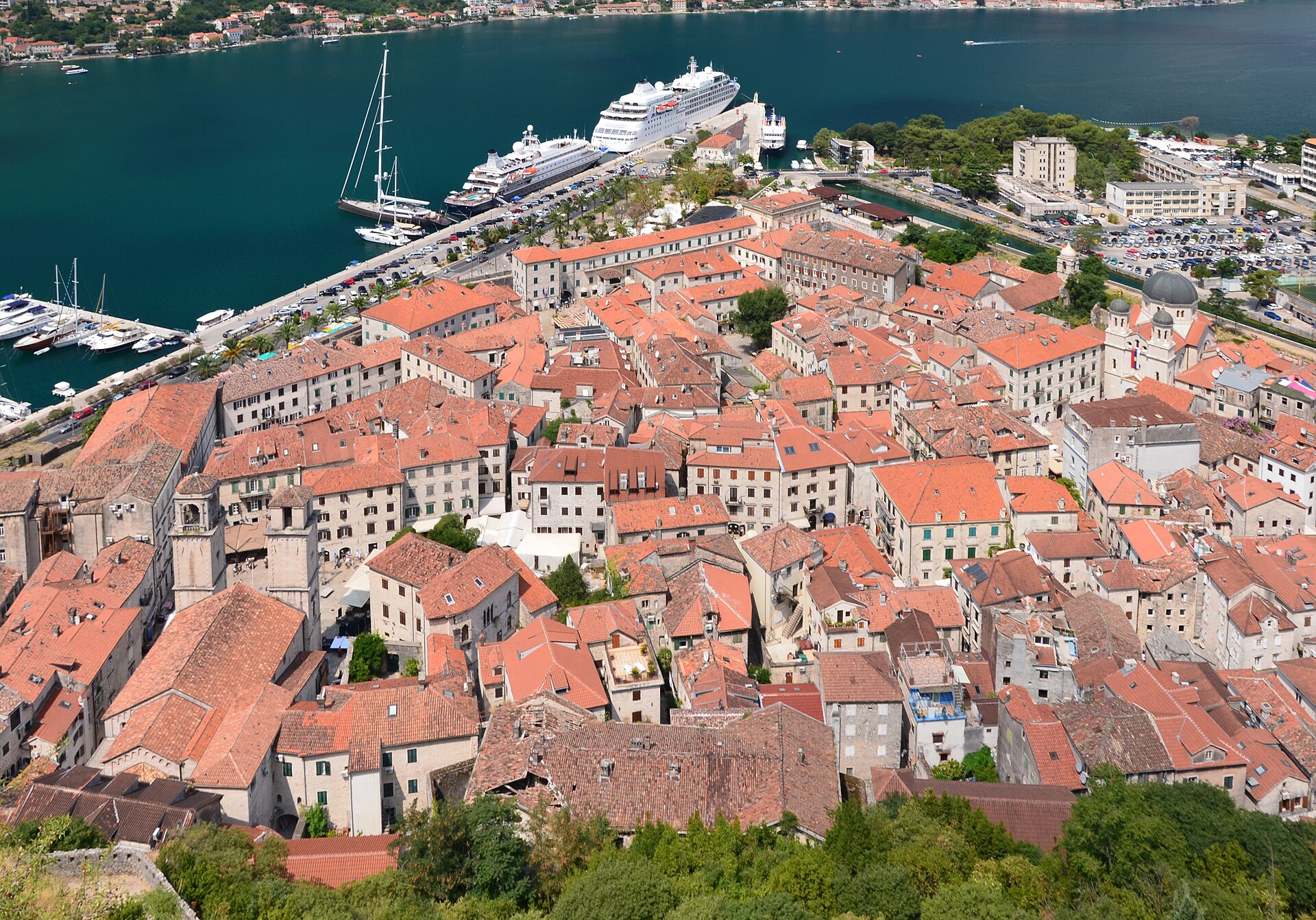 A narrow stone lane lined with cafe tables in the old town of Kotor
