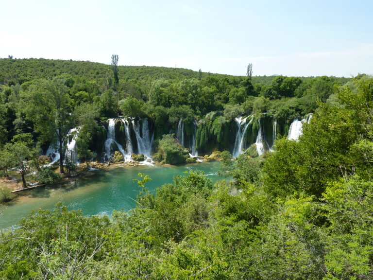 The horseshoe of Kravice Waterfalls dropping into a green pool south of Mostar