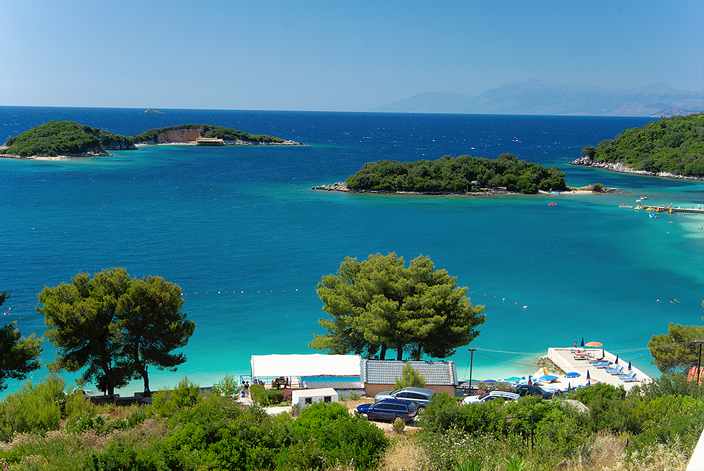 Sunbeds and blue water at Ksamil beach, an affordable Albanian Riviera stop