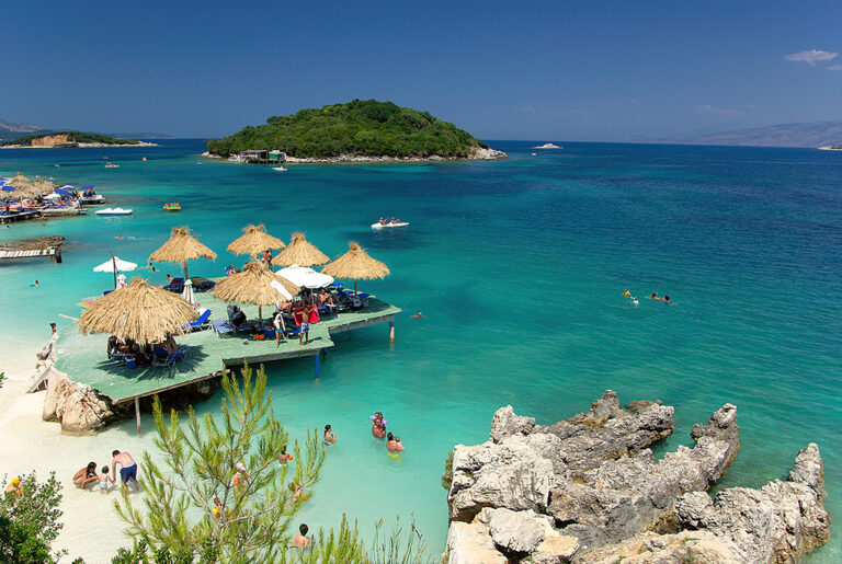 Turquoise water and islets off Ksamil beach on the Albanian Riviera in summer