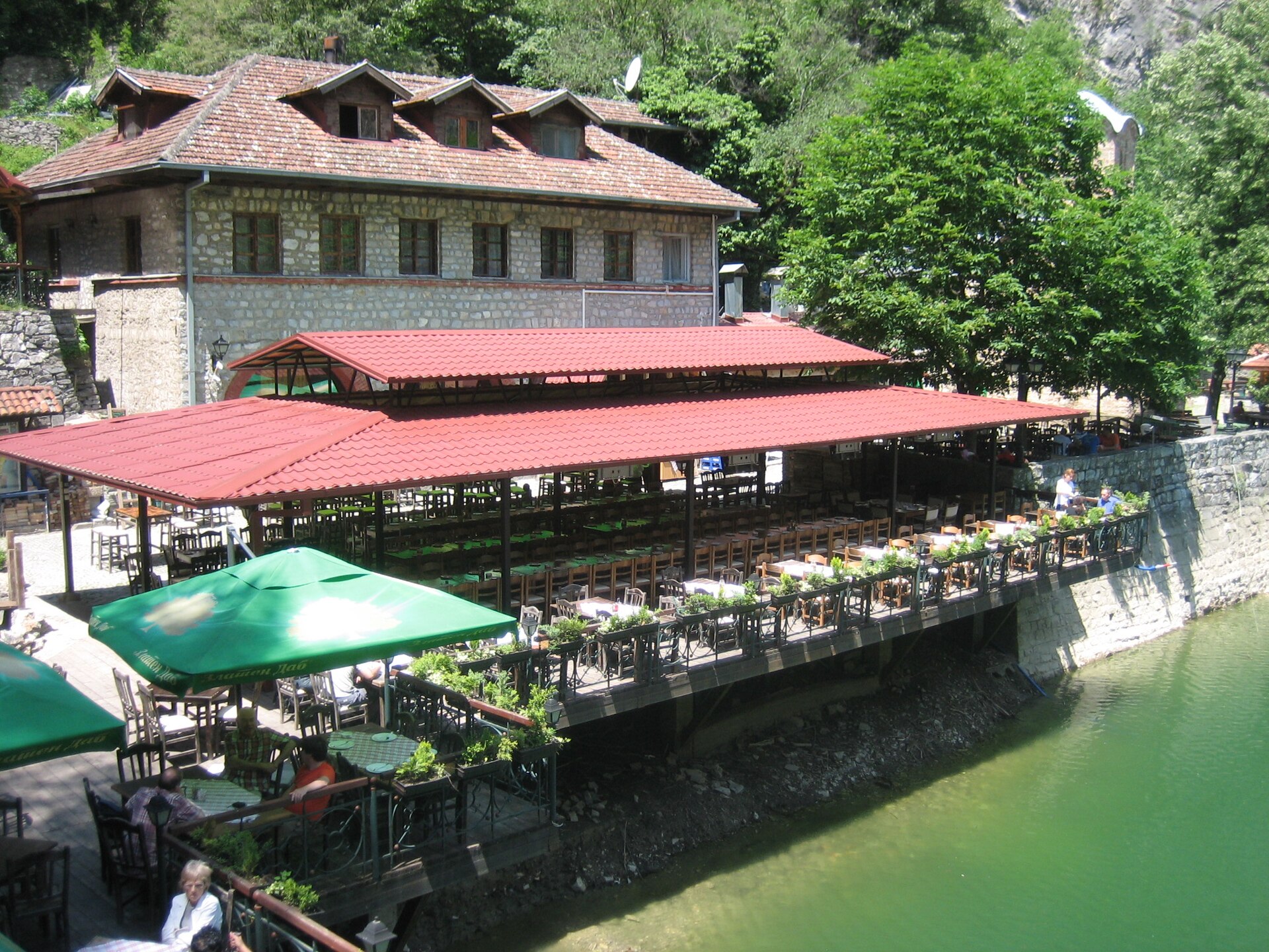 Terrace restaurant and the Monastery of St. Andrew beside the dam at Matka Canyon