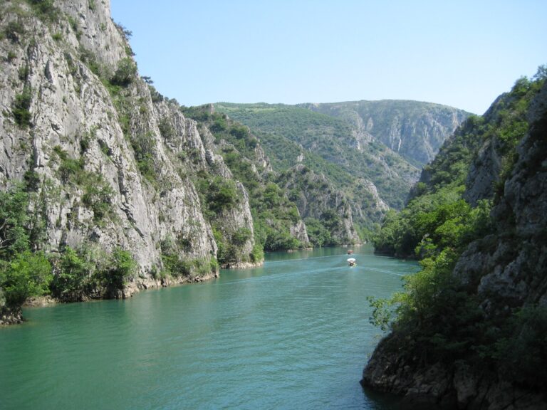 Emerald green Lake Matka winding between limestone cliffs in Matka Canyon near Skopje