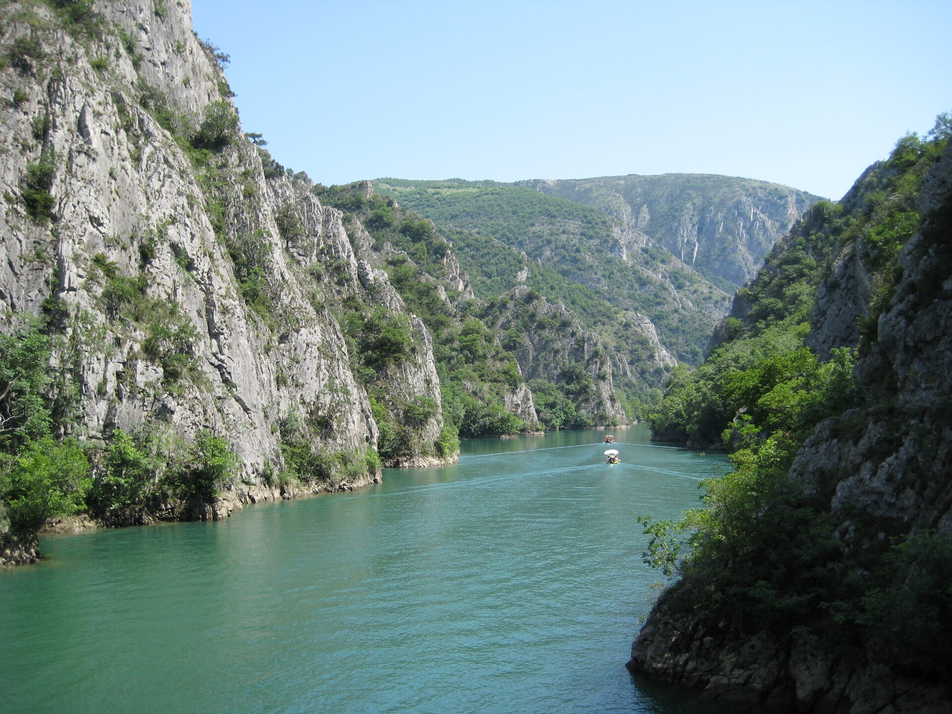 Emerald green Lake Matka winding between limestone cliffs in Matka Canyon near Skopje