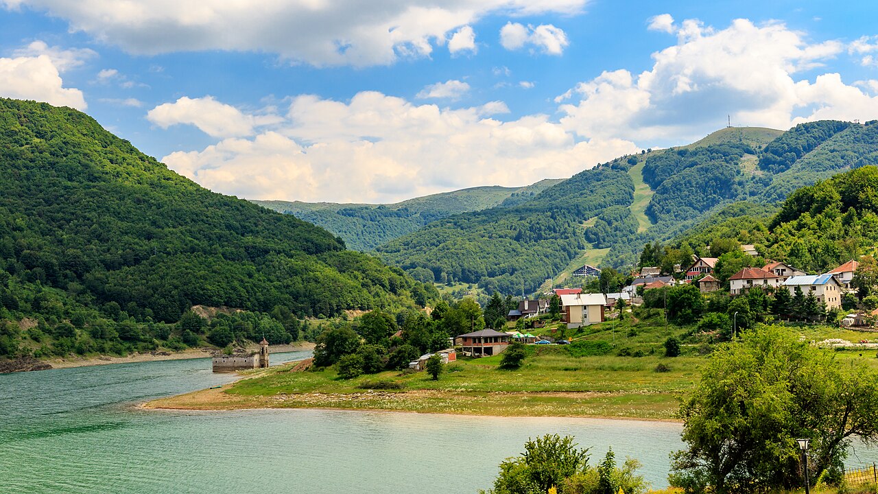 Mavrovo Lake and the village of Mavrovo surrounded by green mountains