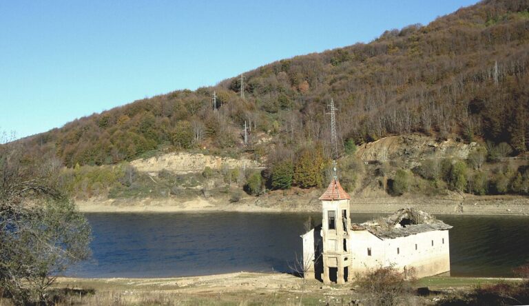 Half submerged Church of St. Nicholas on the shore of Mavrovo Lake in North Macedonia