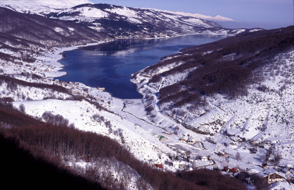 Snow-covered hills and Lake Mavrovo in winter, North Macedonia