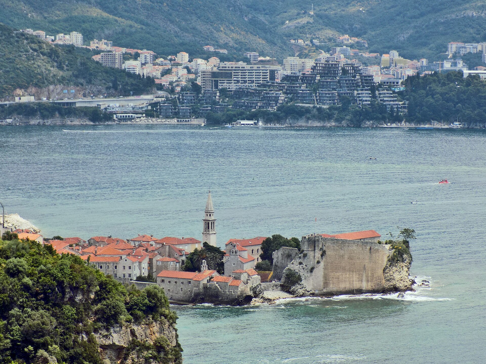 Cliffs and clear turquoise water near Mogren Beach in Budva, Montenegro