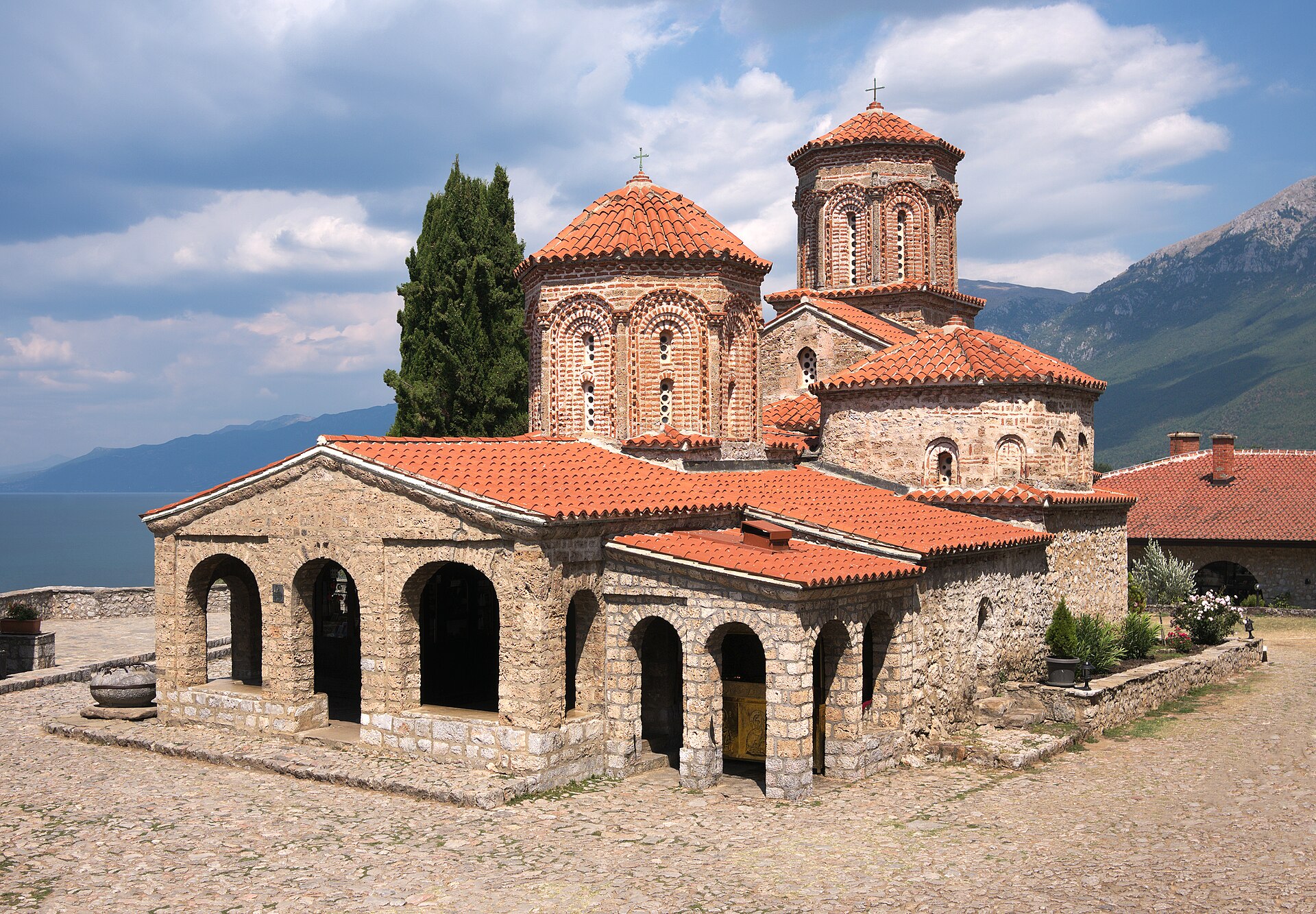 Stone domes of the Monastery of St. Naum under a blue sky on the shore of Lake Ohrid