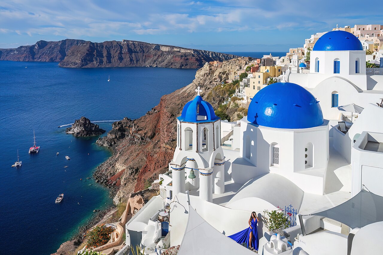 Three blue domed churches above the caldera in Oia on Santorini, Greece
