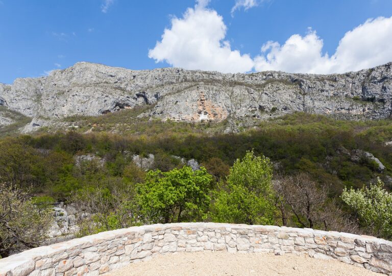 Ostrog Monastery built into a white cliff face in the Montenegrin mountains