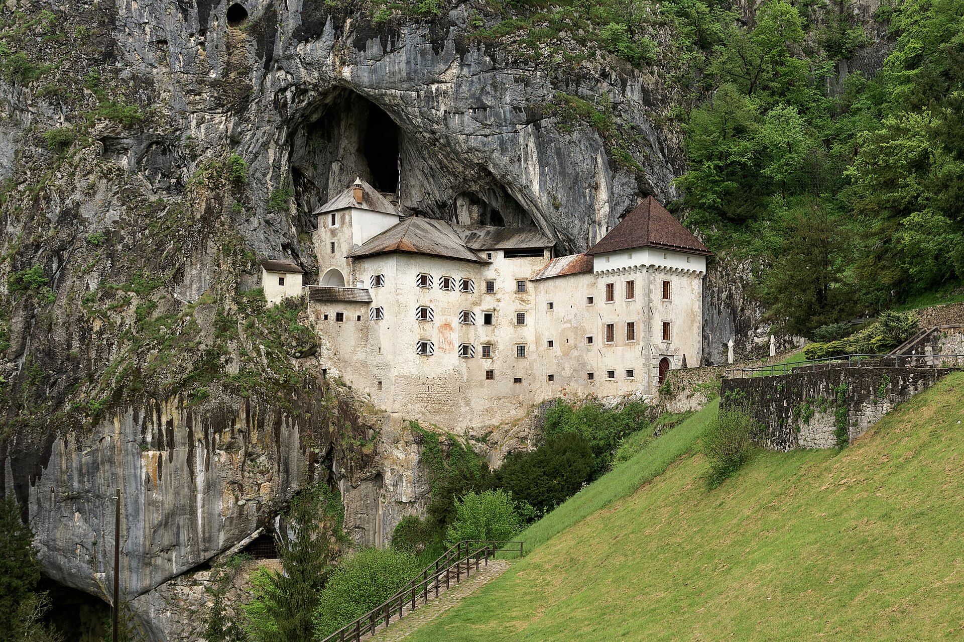 Predjama Castle set into the mouth of a limestone cliff cave in Slovenia