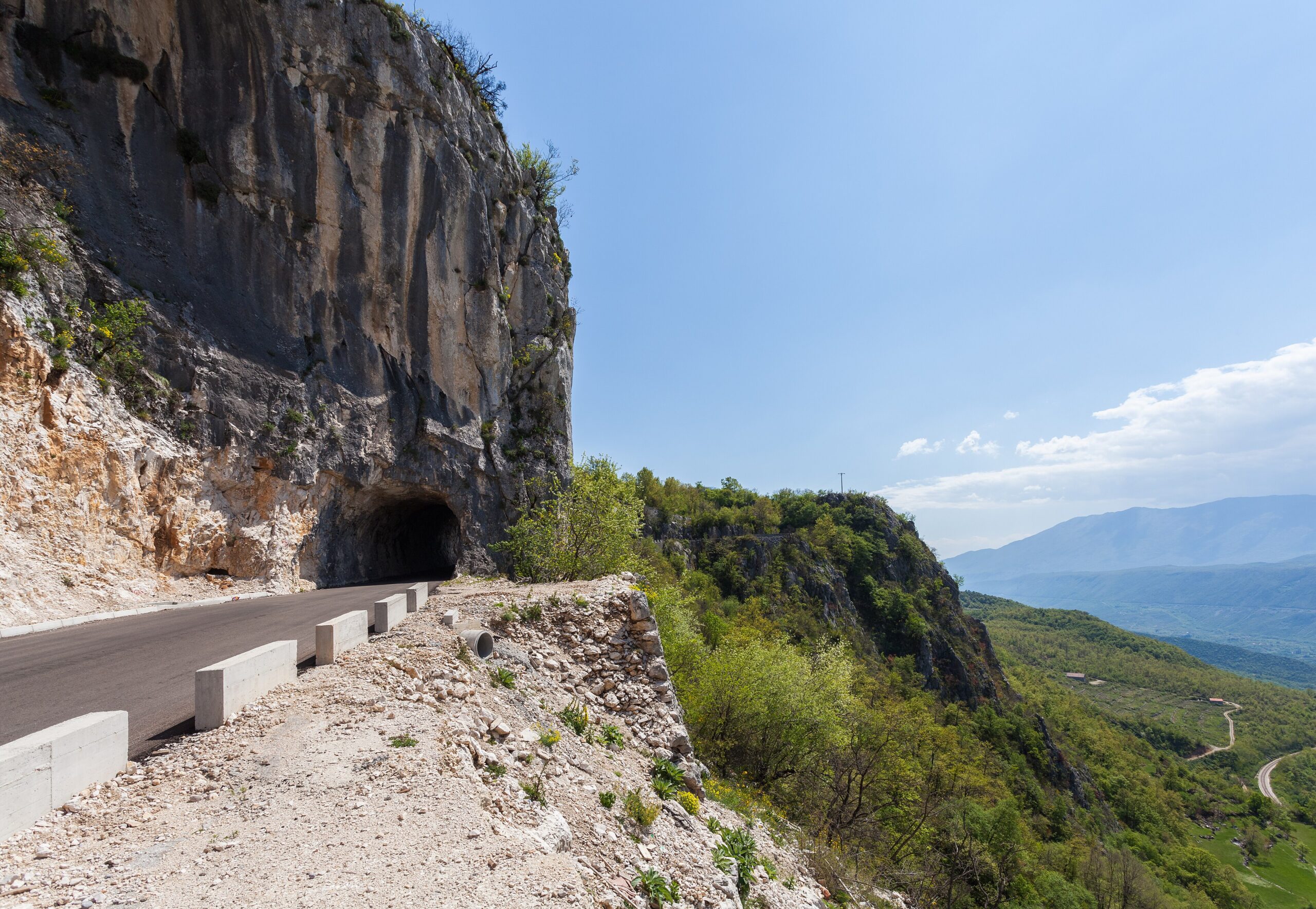 The narrow switchback road climbing through the mountains toward Ostrog Monastery