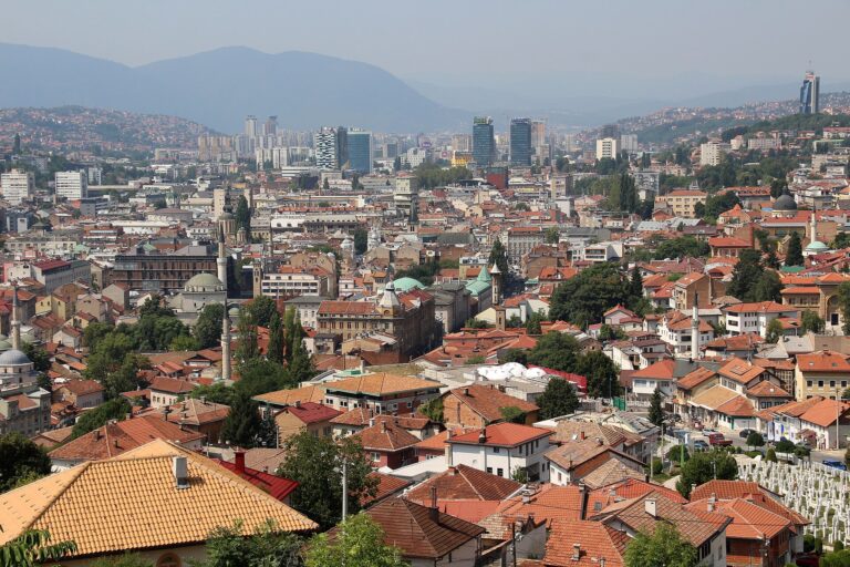 Panoramic view over Sarajevo from the Yellow Fortress with minarets and red rooftops filling the valley