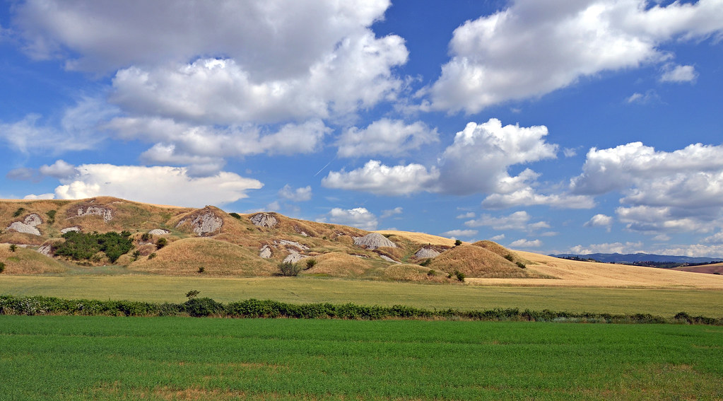 Rolling green hills and big sky in the Tuscan countryside of Italy